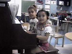Playroom fun: sisters at the piano