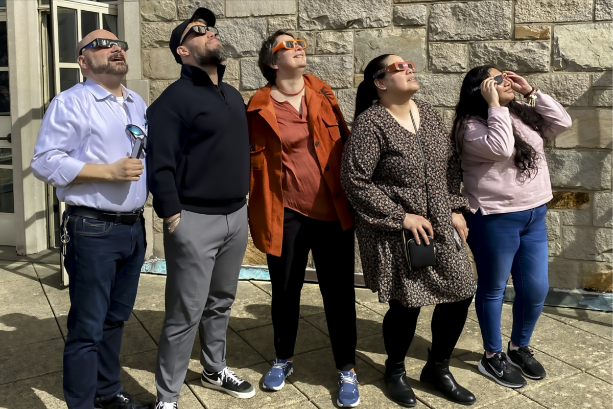 Karl Watson, William Murray, Karin Beck, Beba Alvarado, and Michelle Flores watch Monday's solar eclipse.  (Photo by Alejandro Castro) Check out the full issue for more photos.
