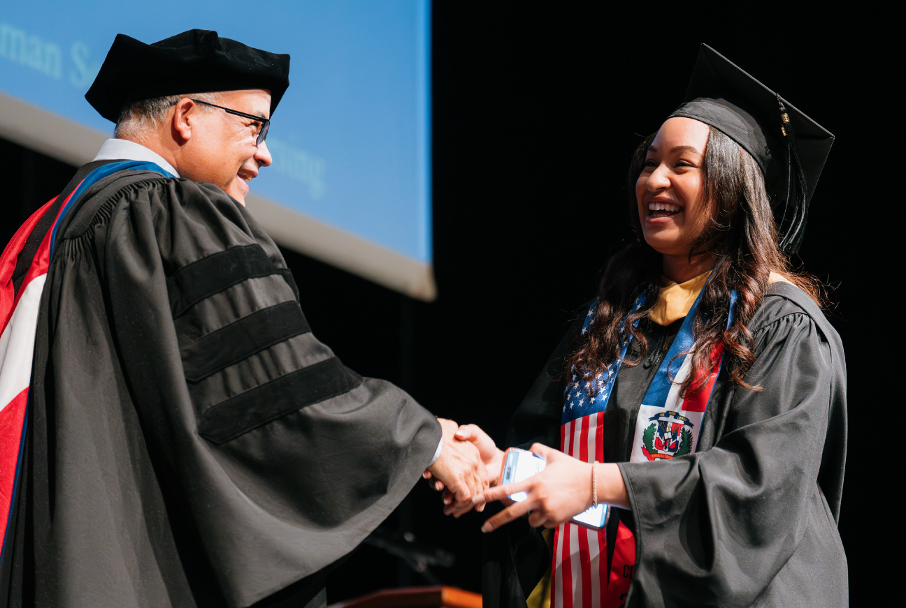 Photo of Provost congratulating student at Lehman Undergraduate Commencement