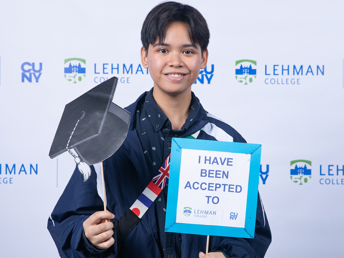 Photo of student with Lehman signs