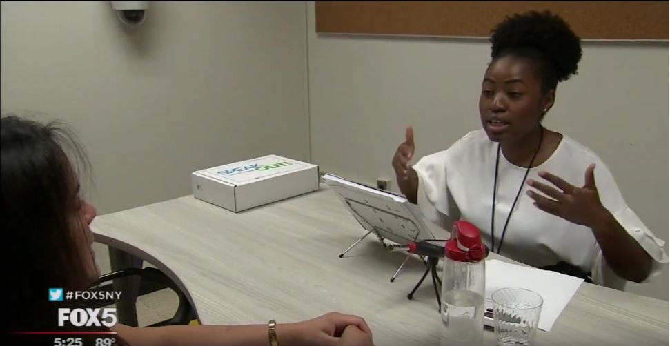 Student clinician Suzette Espeut assists a patient at the Lehman College Parkinson's Clini