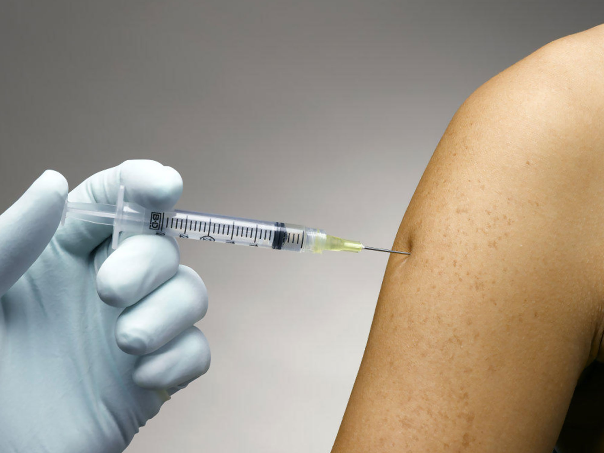 Photo of nurse giving a student a flu shot.