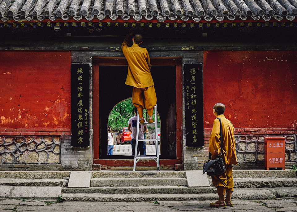 Two Buddhist monks repairing a temple