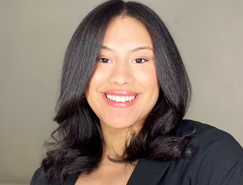 A head shot of Katherine Sanchez, a woman with dark hair smiling.