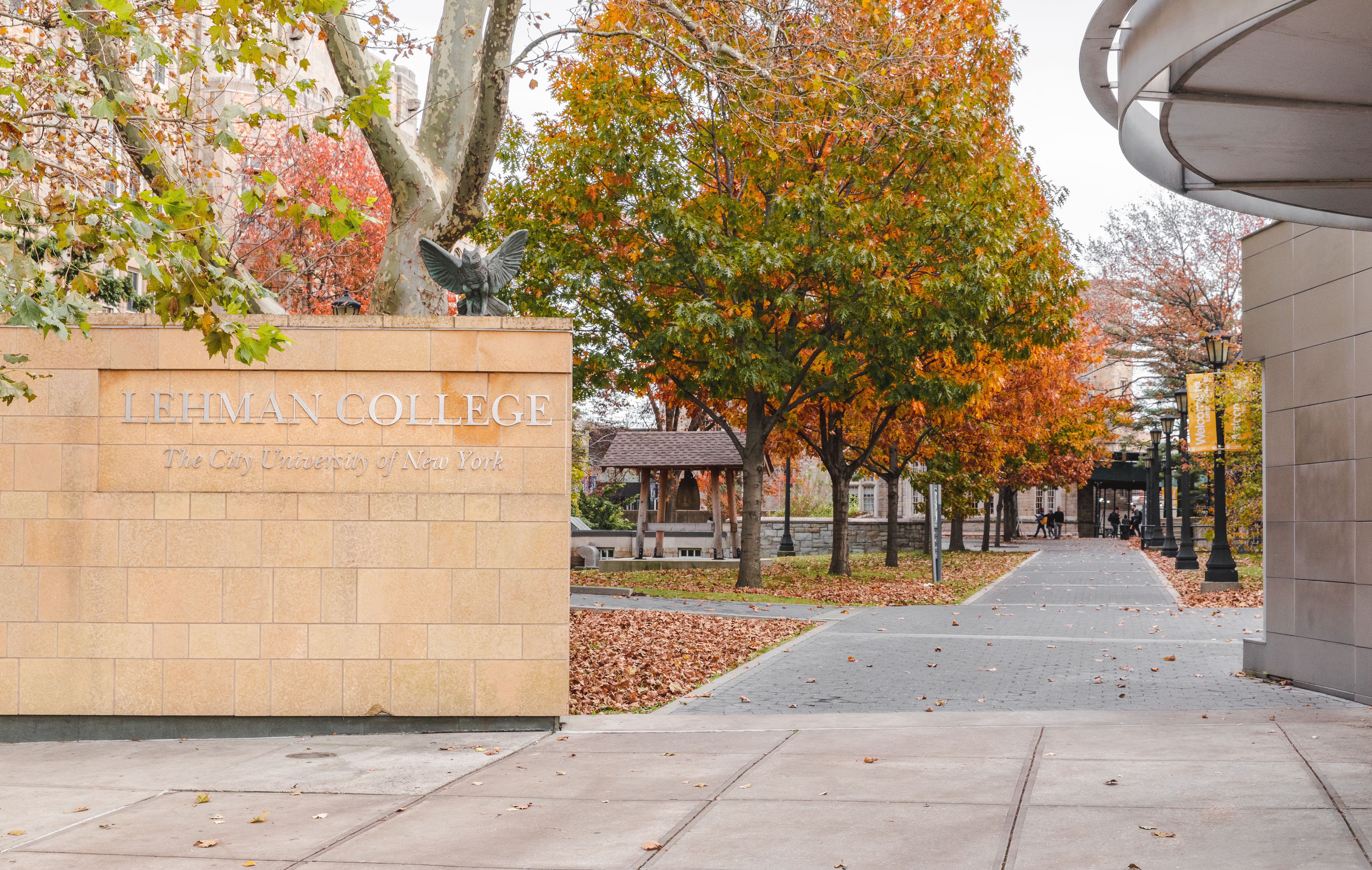 gateway to a college campus with trees.