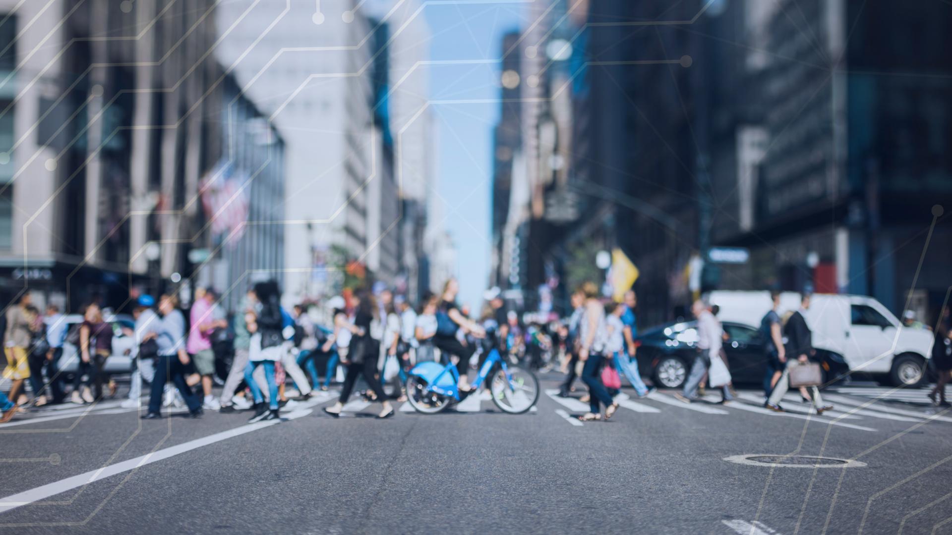 A photograph of pedestrians and bicyclists crossing a street.