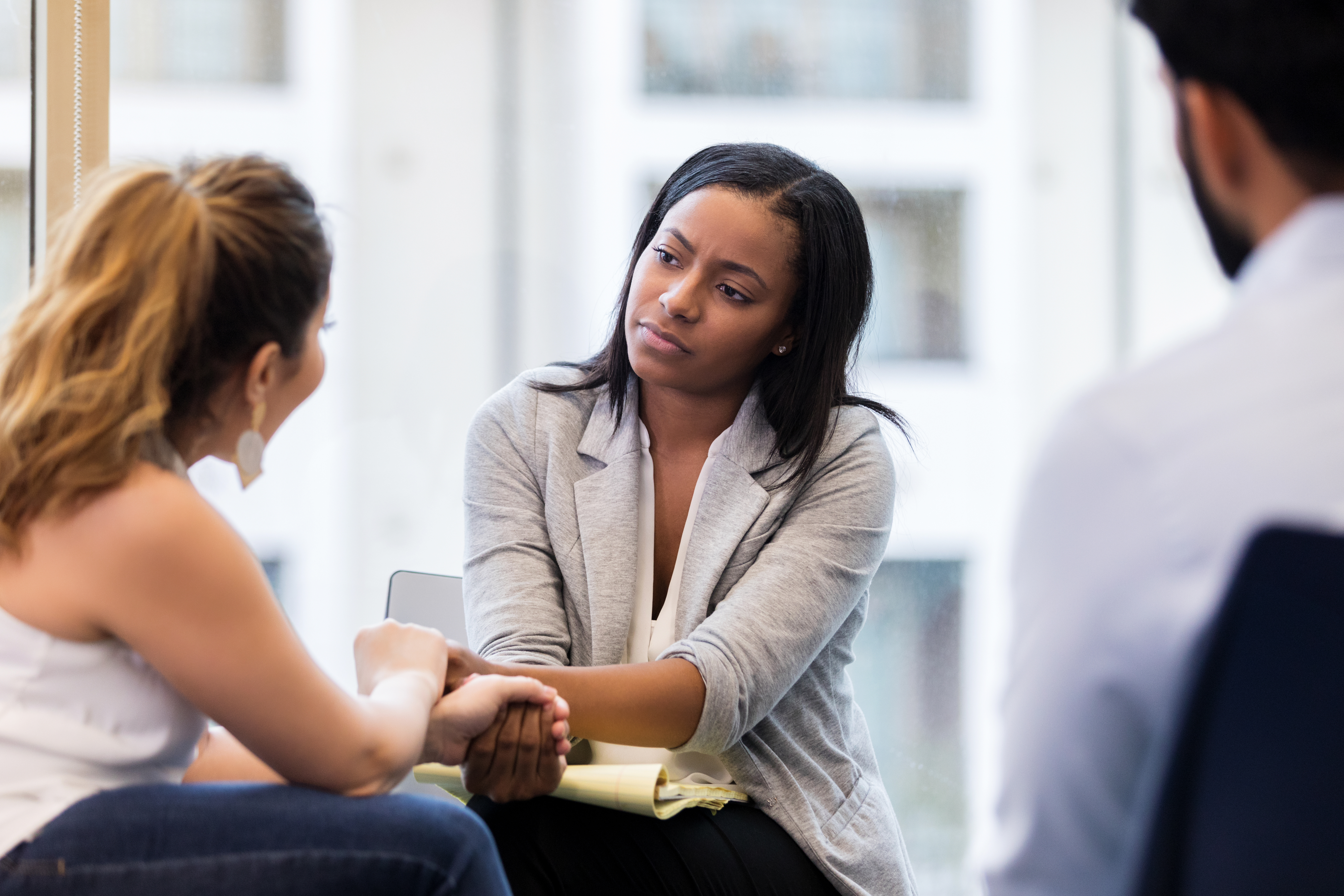 a woman of color listens to her client