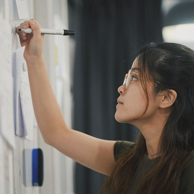 Student Writing on White Board