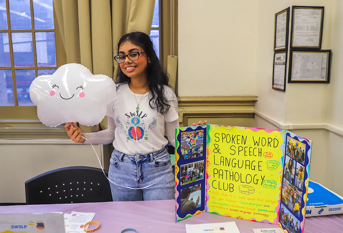 Speech Language Club Rep with Cloud Balloon at Club Fair