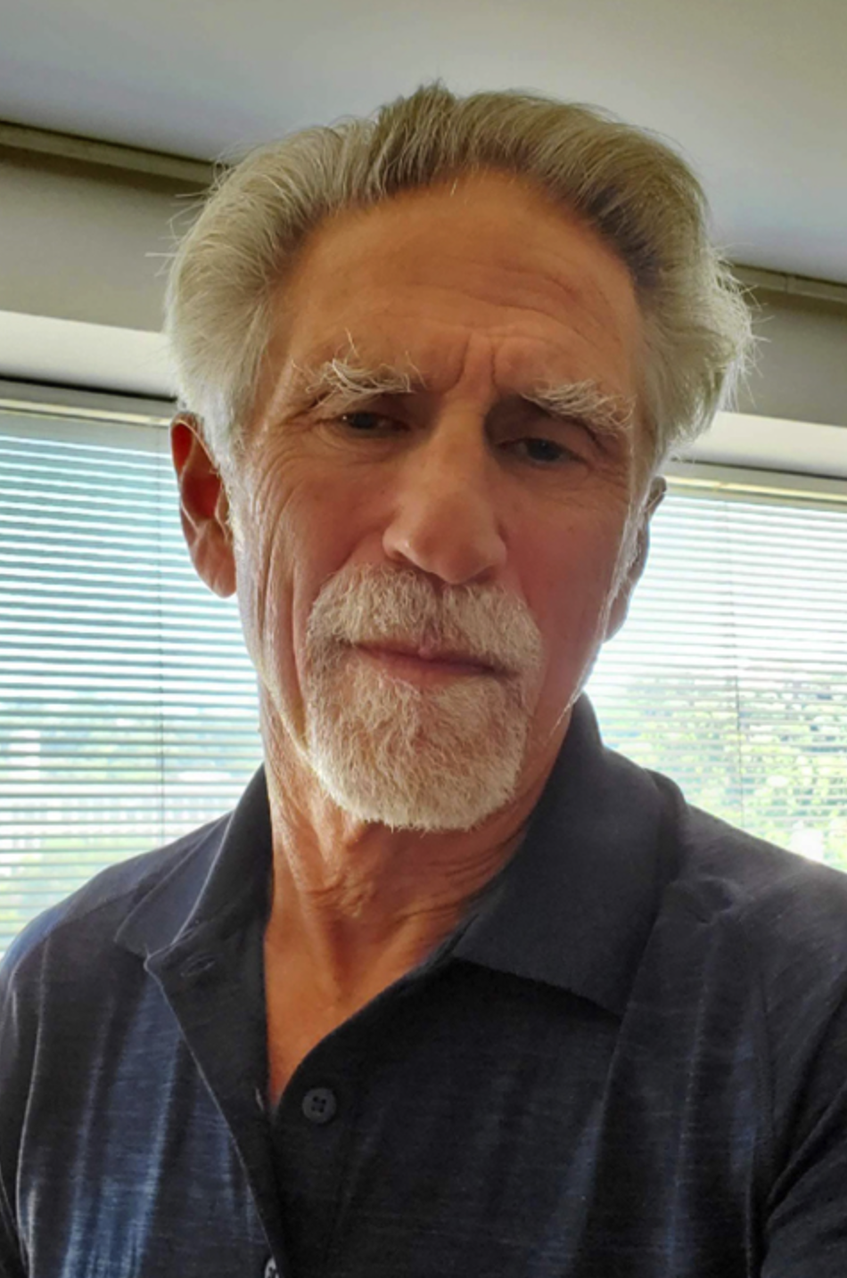 Bearded man with gray hair.