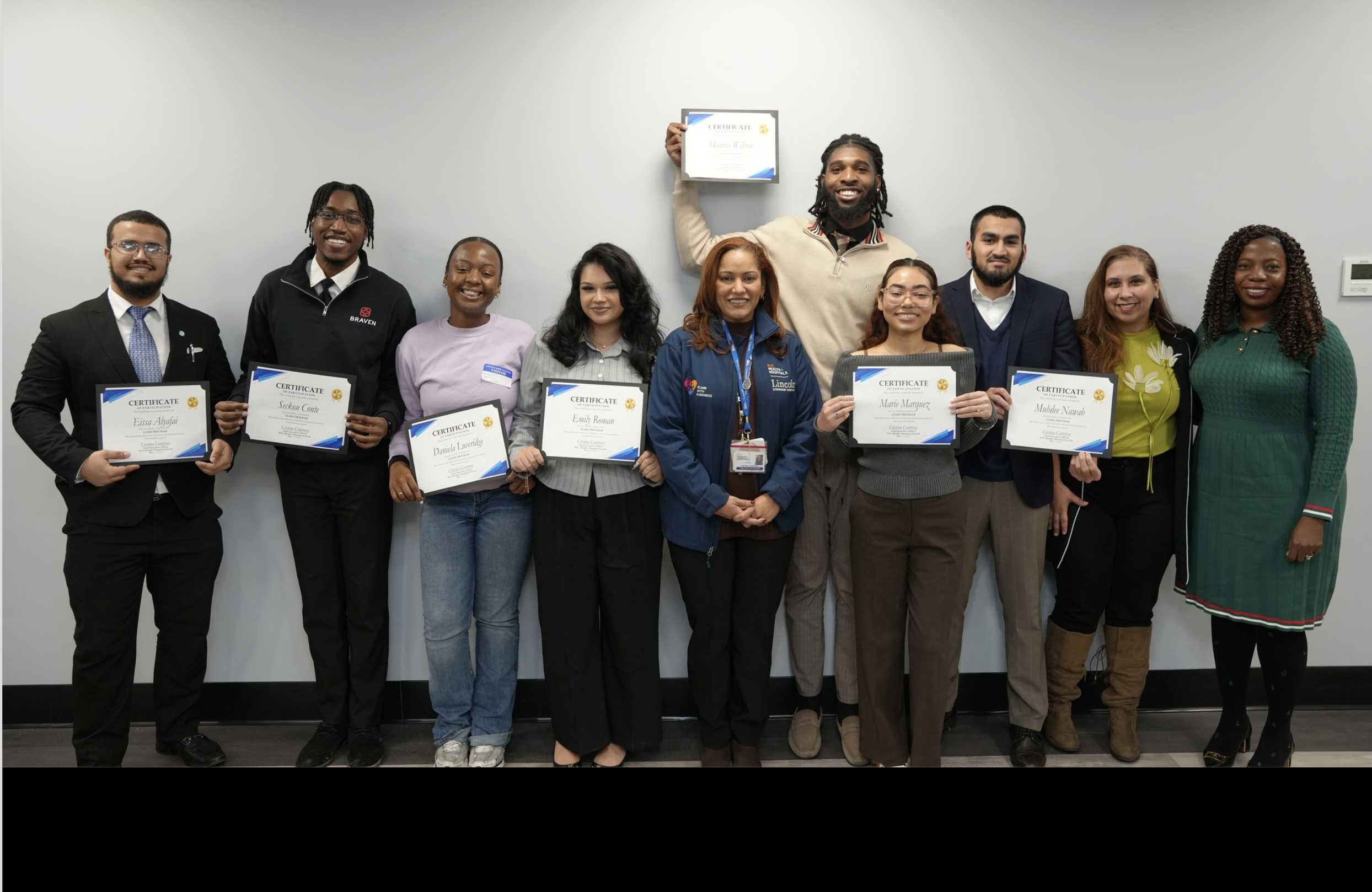 a group of interns holding certificates poses with Christina Contreras, CEO