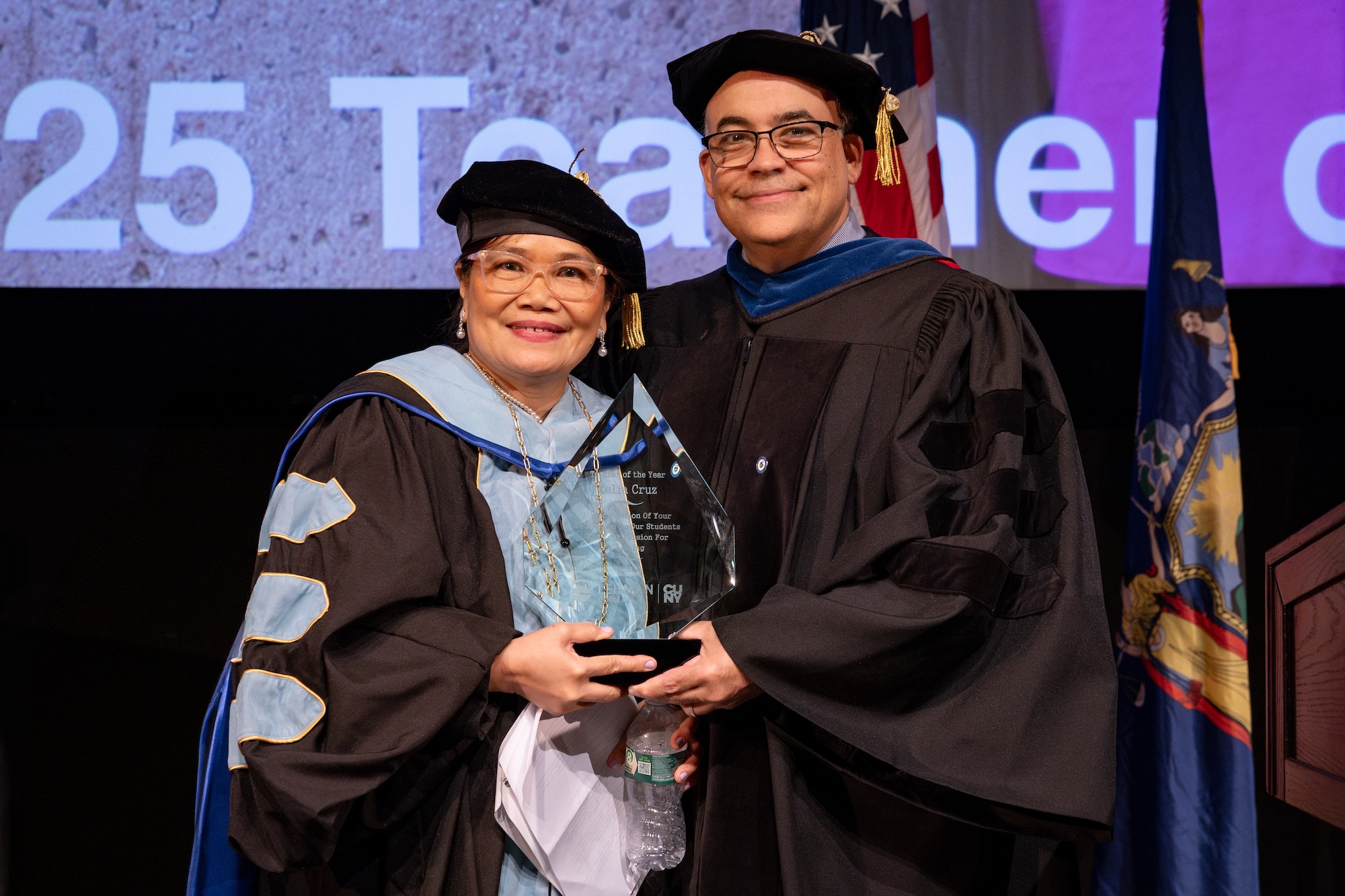 Photo of the Provost giving an award to a faculty