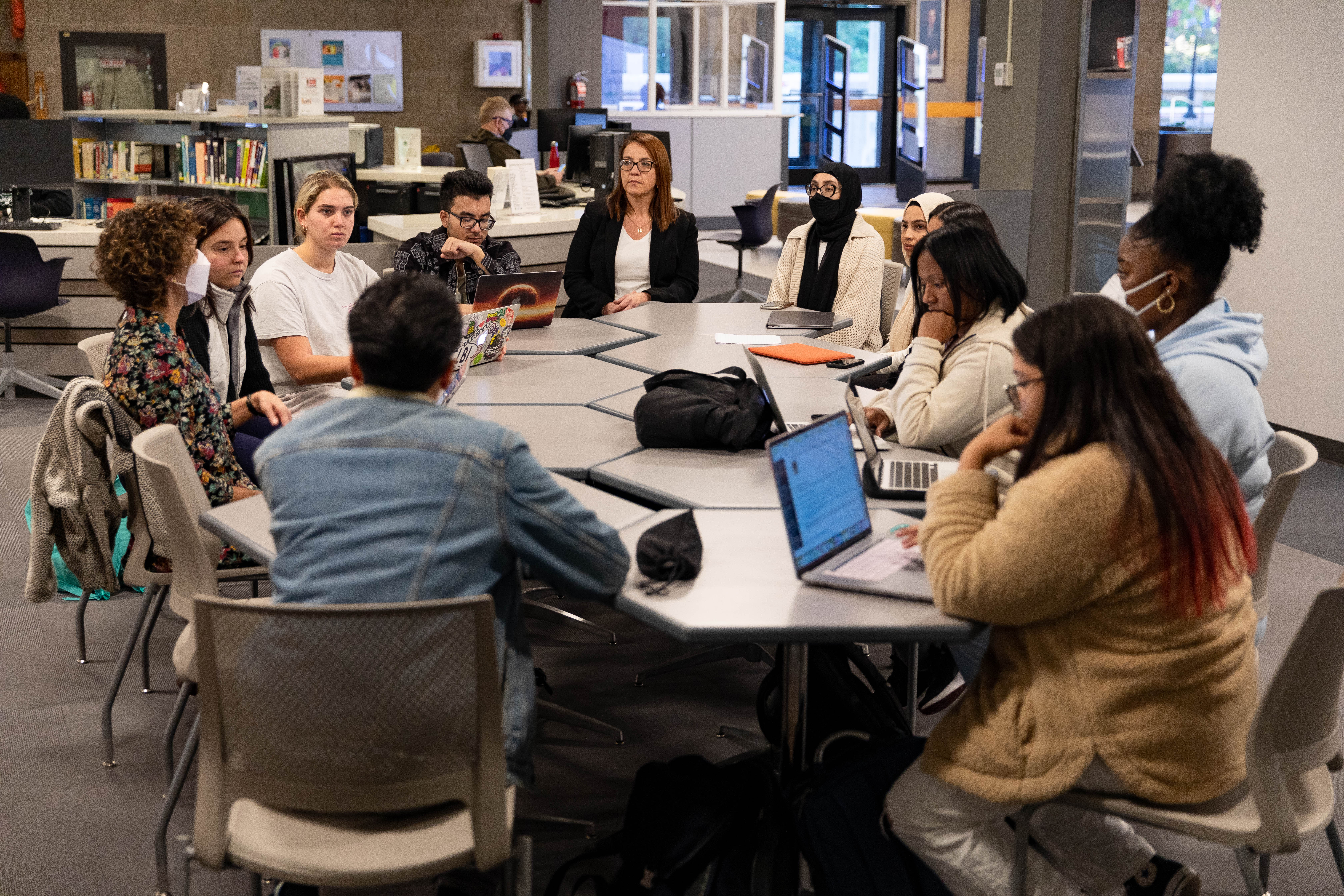 Student sitting around a table discussing