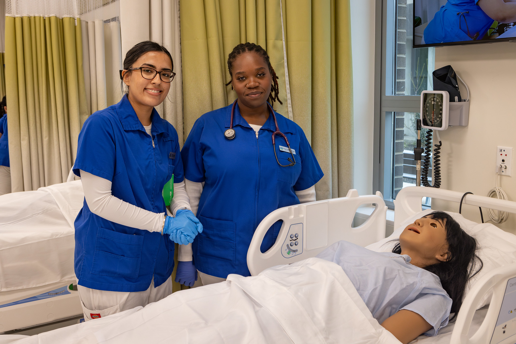 2 Nursing Student looking after a mannequin
