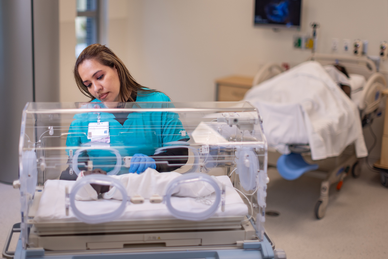 Nursing practicing with a baby mannequin