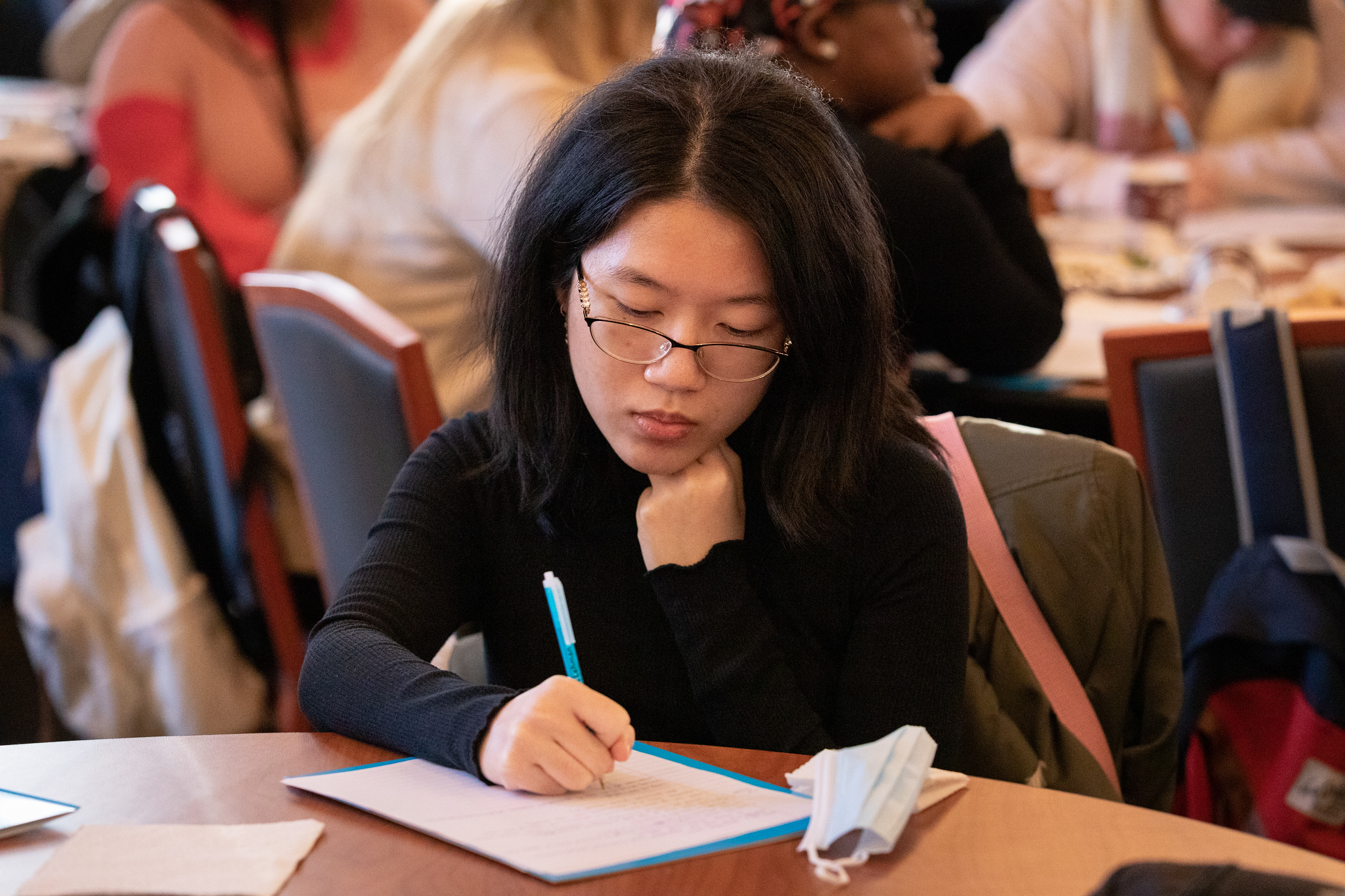 Women taking notes at a table