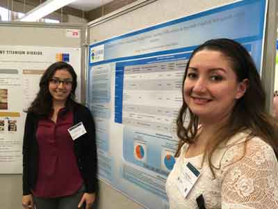 Photo of Angie Beltre (right) Kathy Velasco (left) presenting a poster